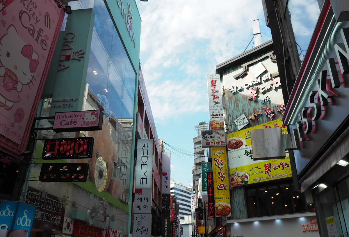 Storefronts and signage on a Myeongdong shopping street in Seoul