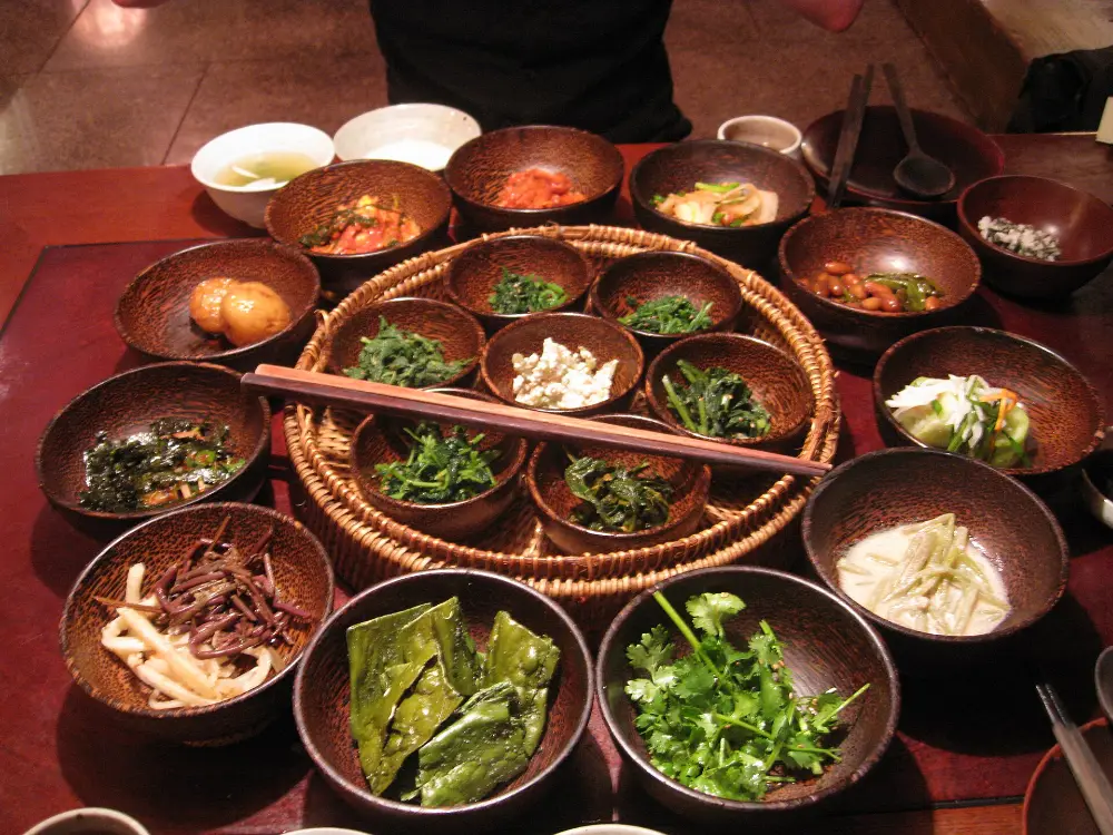 Banchan side dishes laid out on a Korean restaurant table