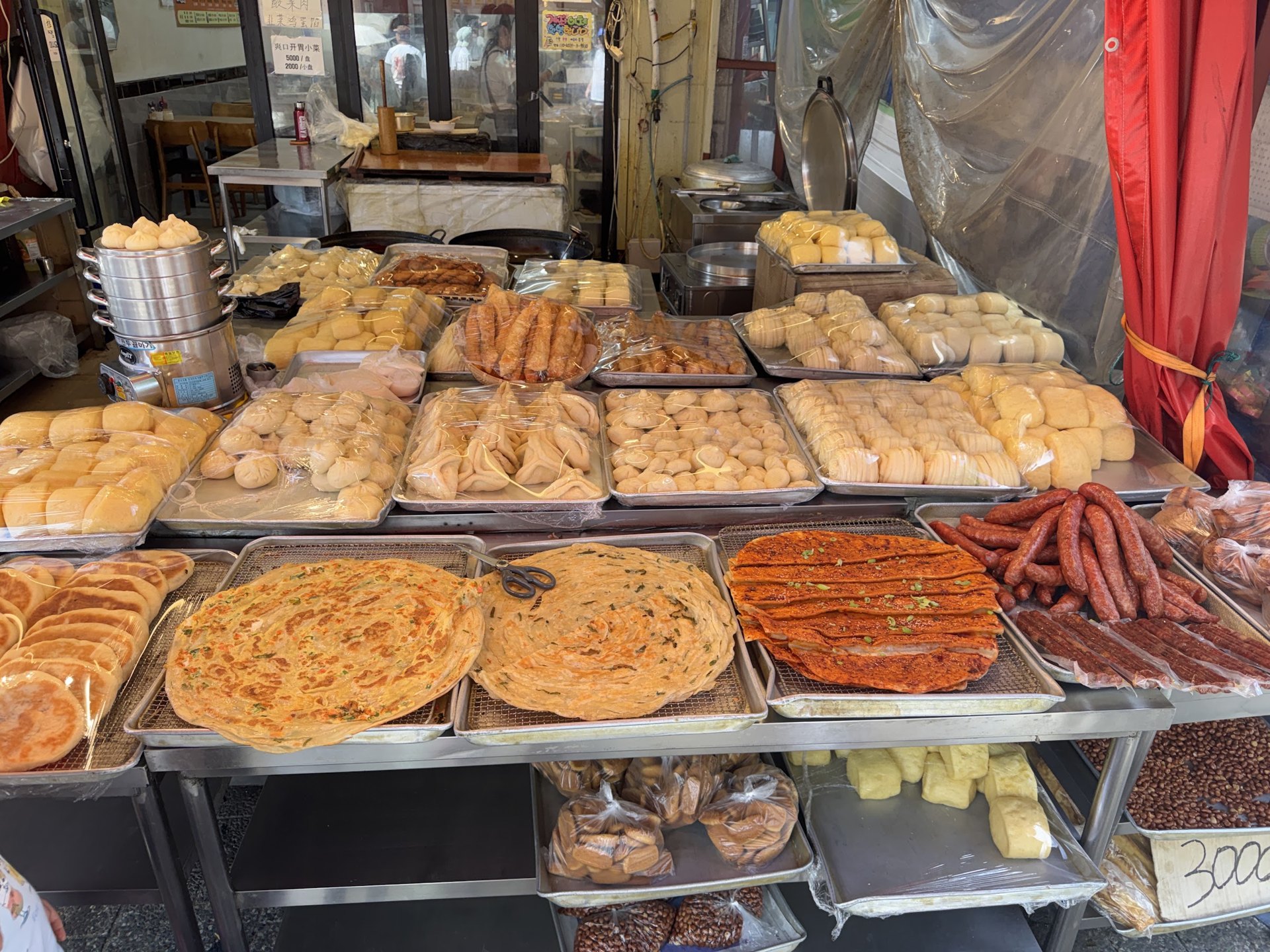 A Chinese street stall display laid out with breads and sausages