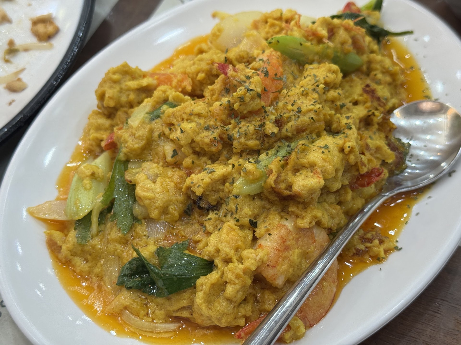 Yellow poo pad pong curry with crab meat and egg