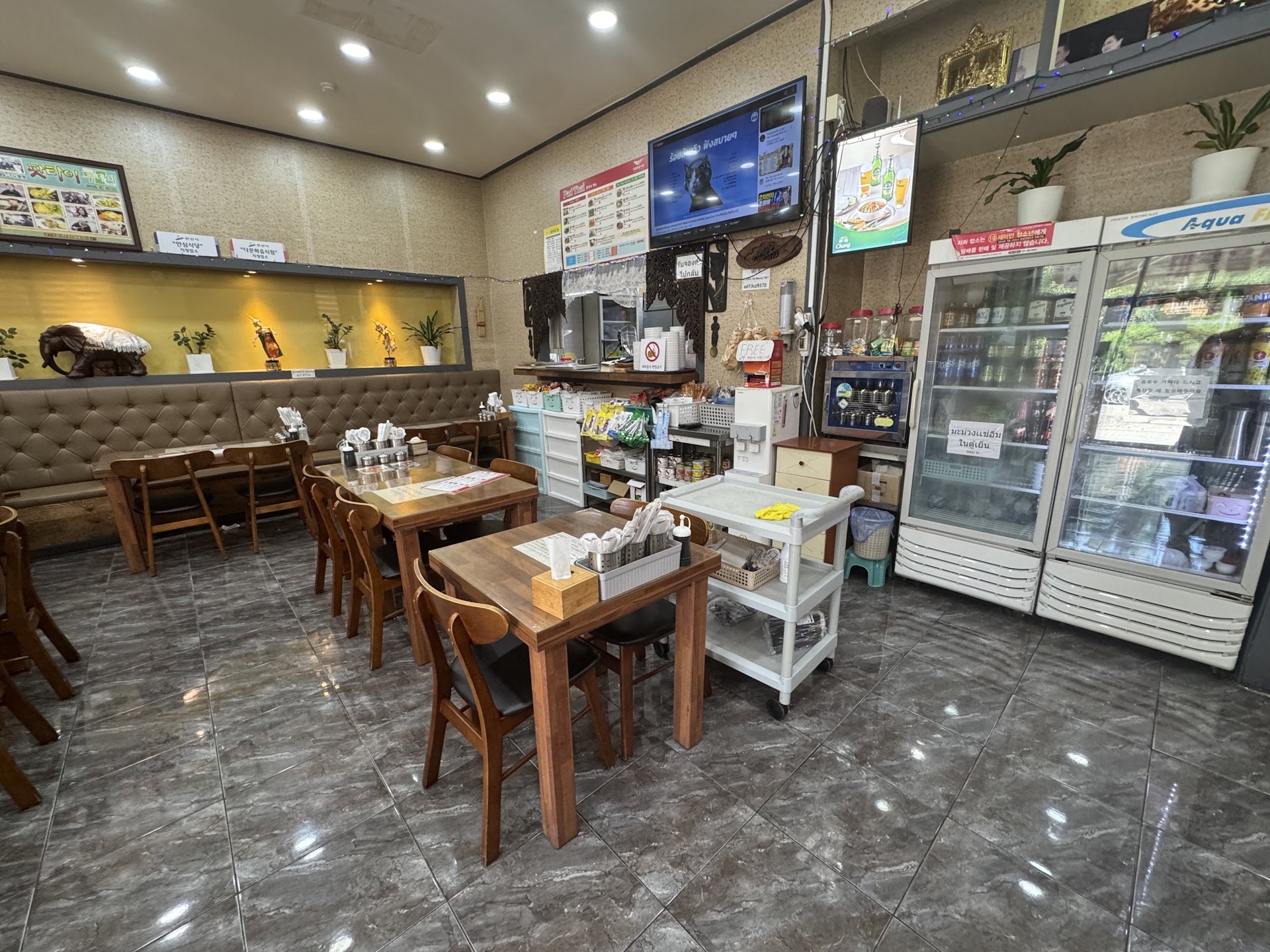 The interior of a Thai restaurant with photo menus on the wall