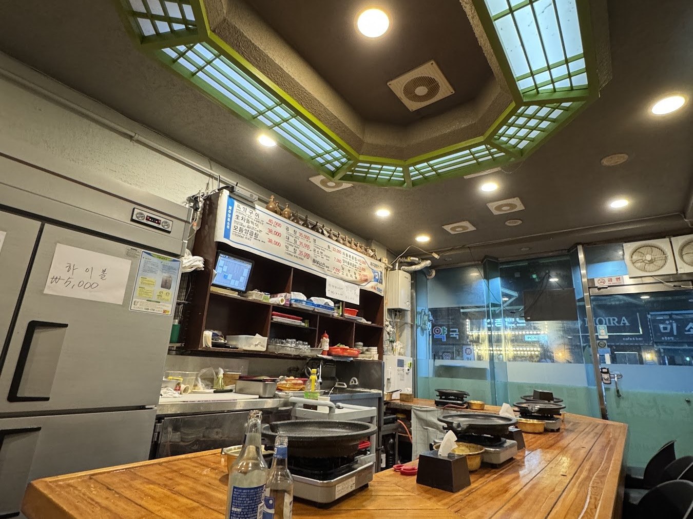 木桌上嵌著烤爐的釜山西面牛腸店店內