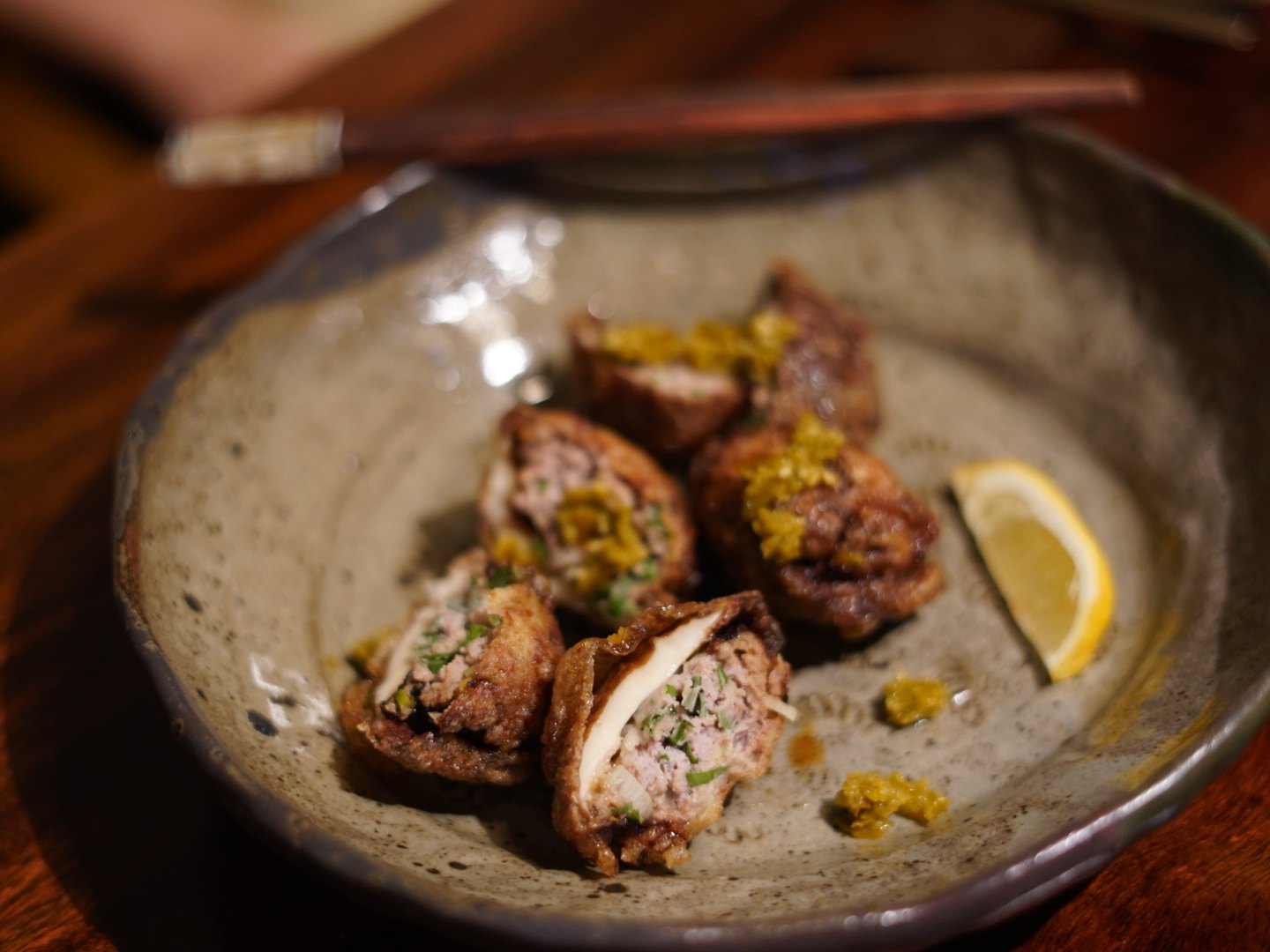 Fried hairtail dumplings topped with a yellow minced sauce