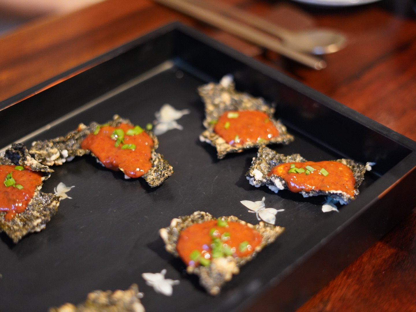 A one-bite dish of roe on fried laver