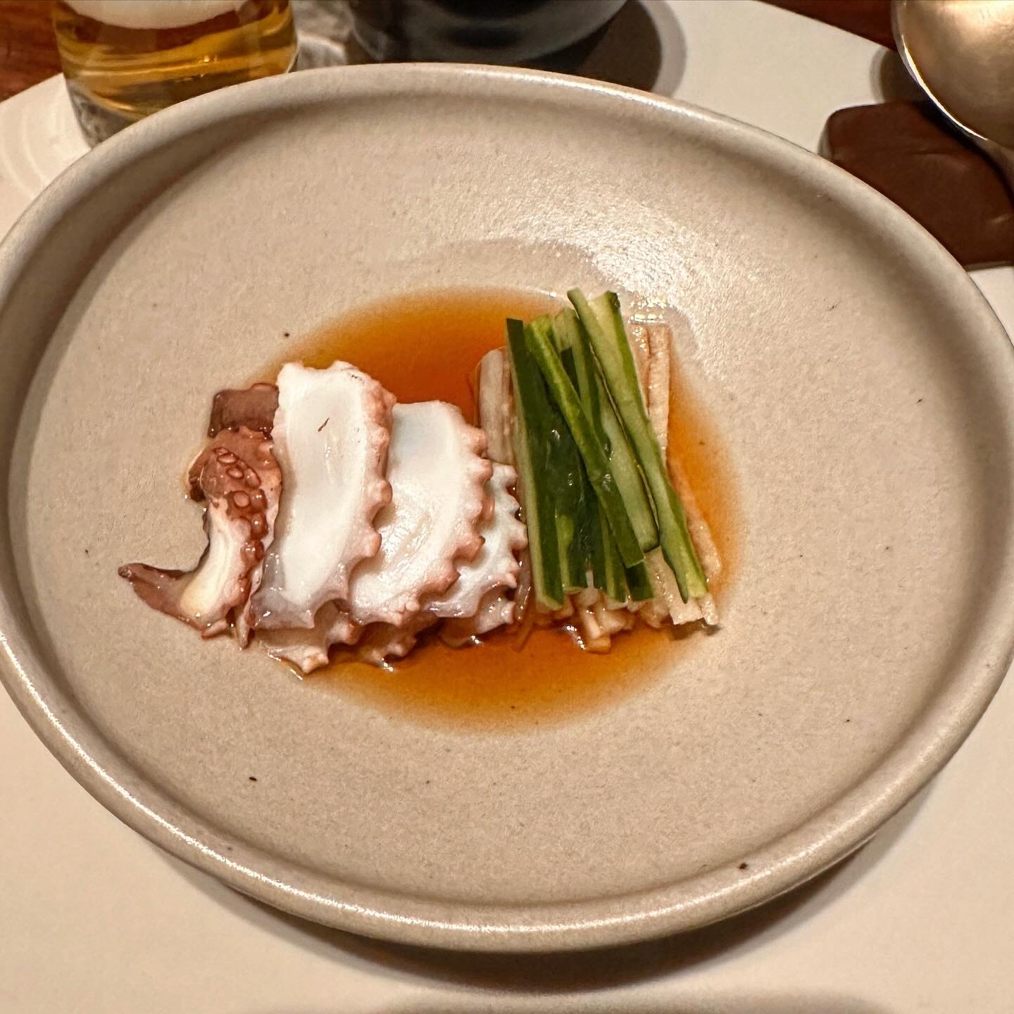 Thinly sliced blanched octopus topped with spring onion
