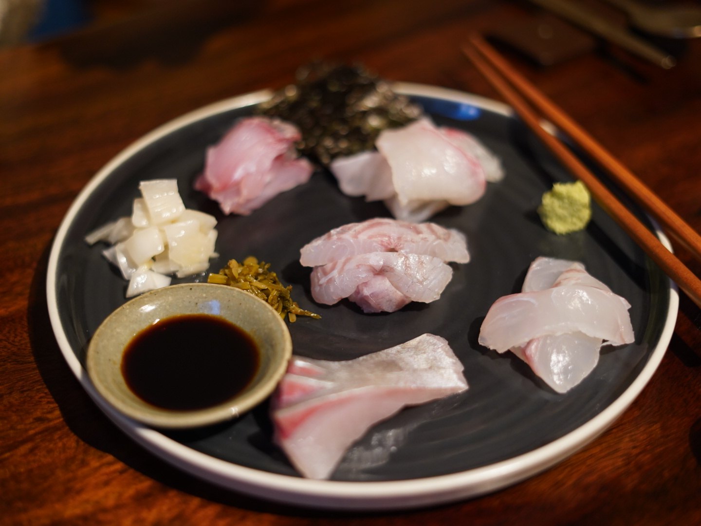 White fish sashimi plated as three separate cuts