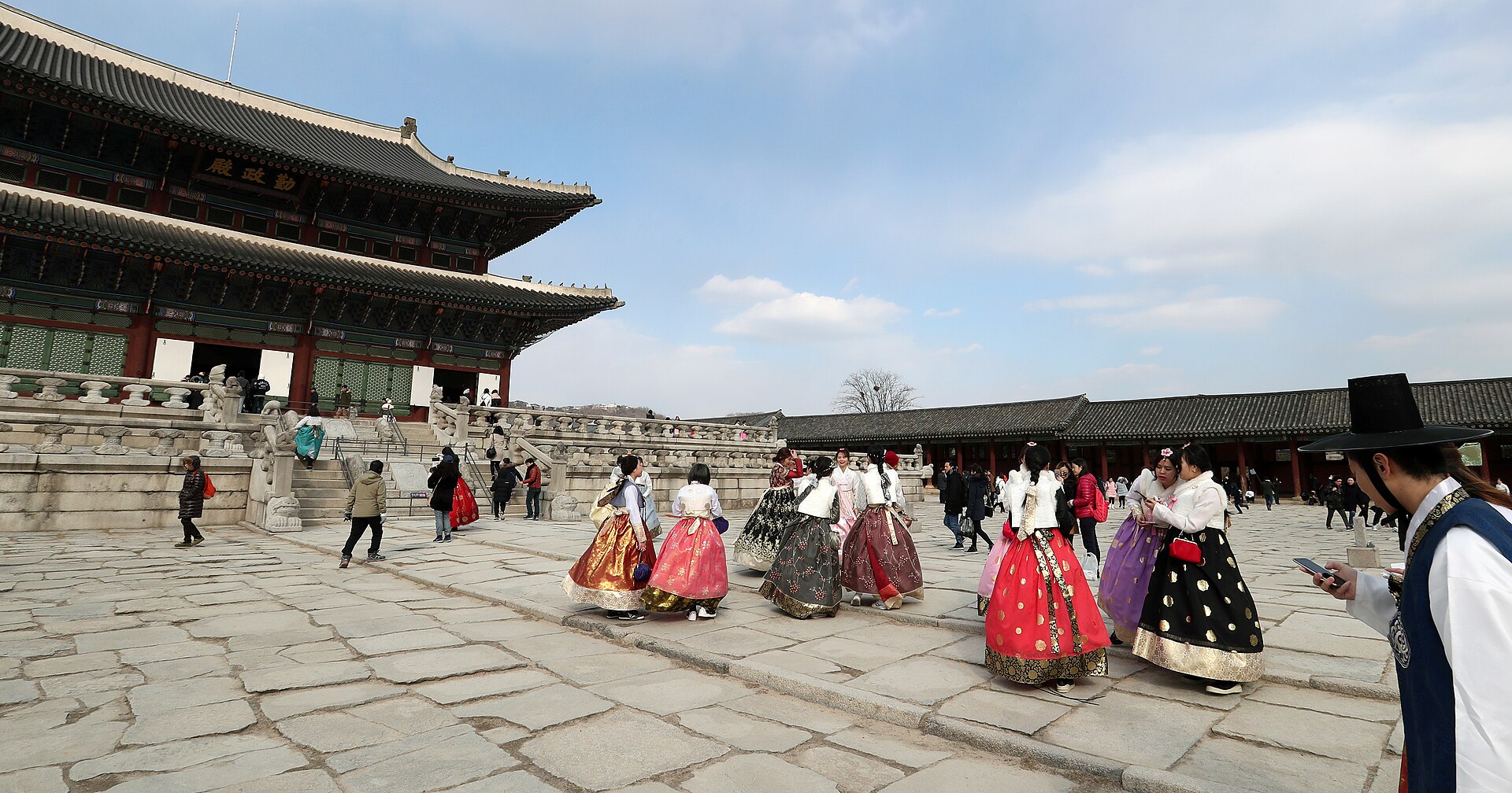 Visitors in hanbok walking through Gyeongbokgung