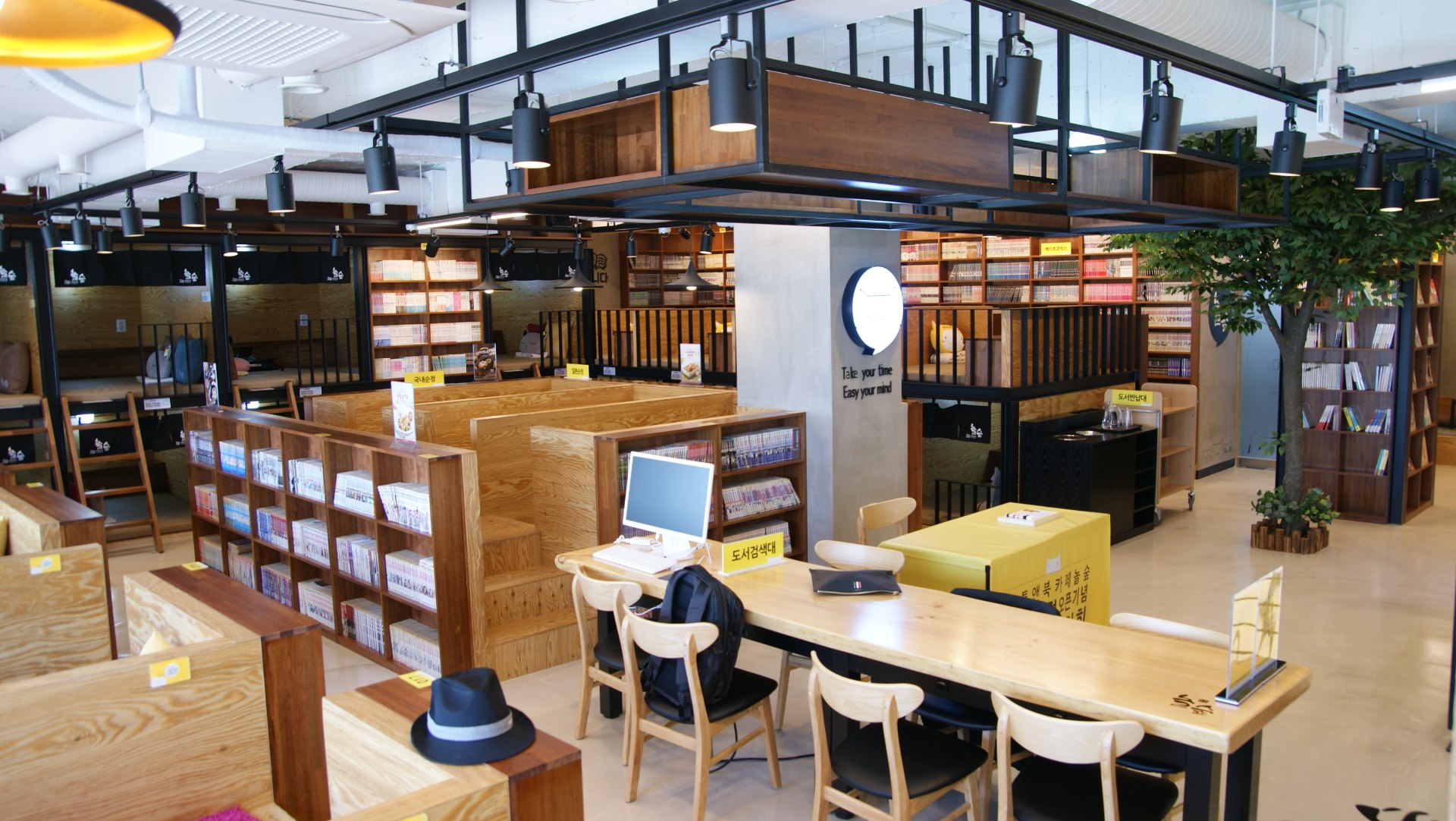Inside a Korean manhwa cafe, with bookshelves and seating