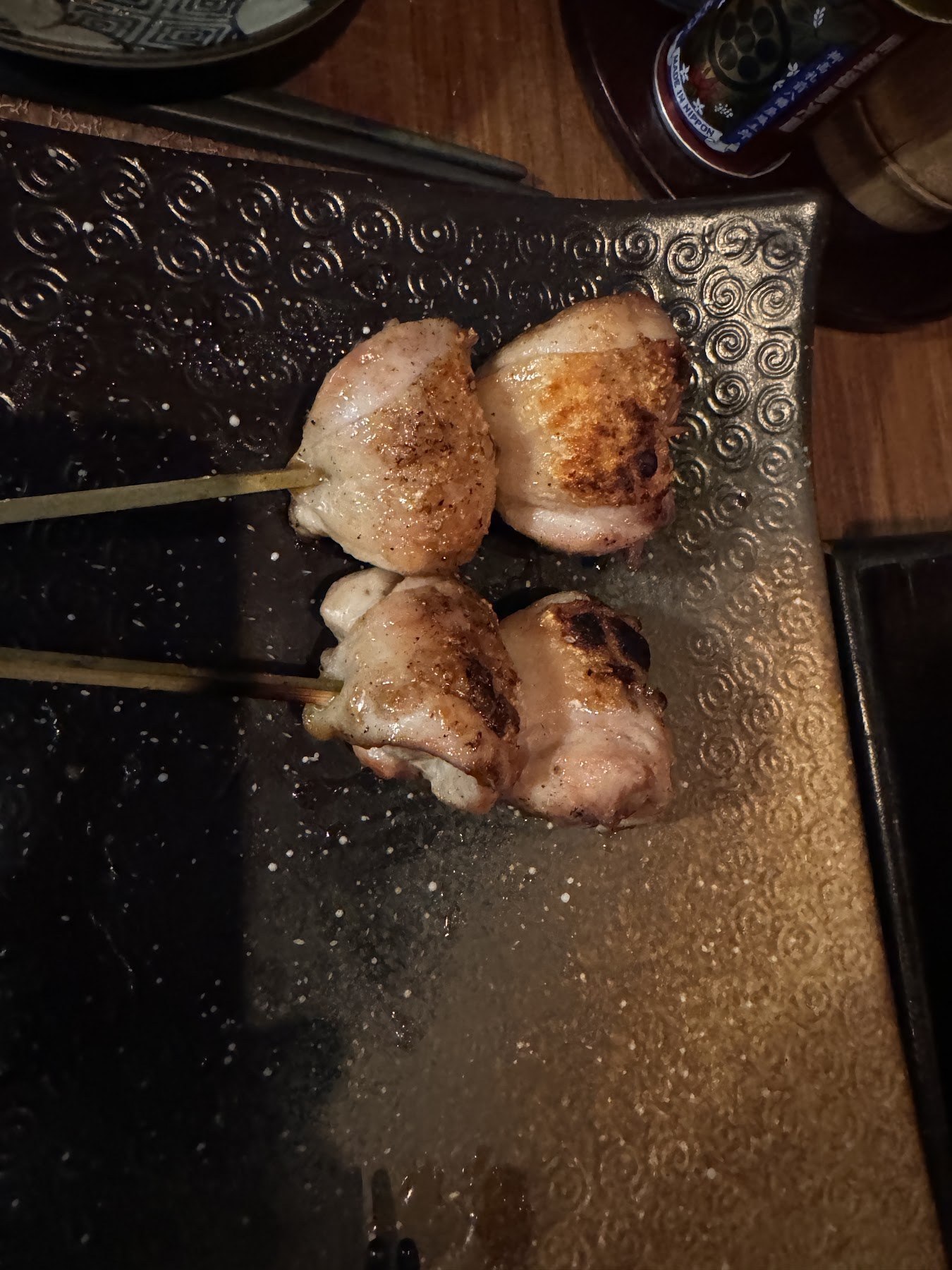 橫放在陶盤上的兩支飽滿雞肉串