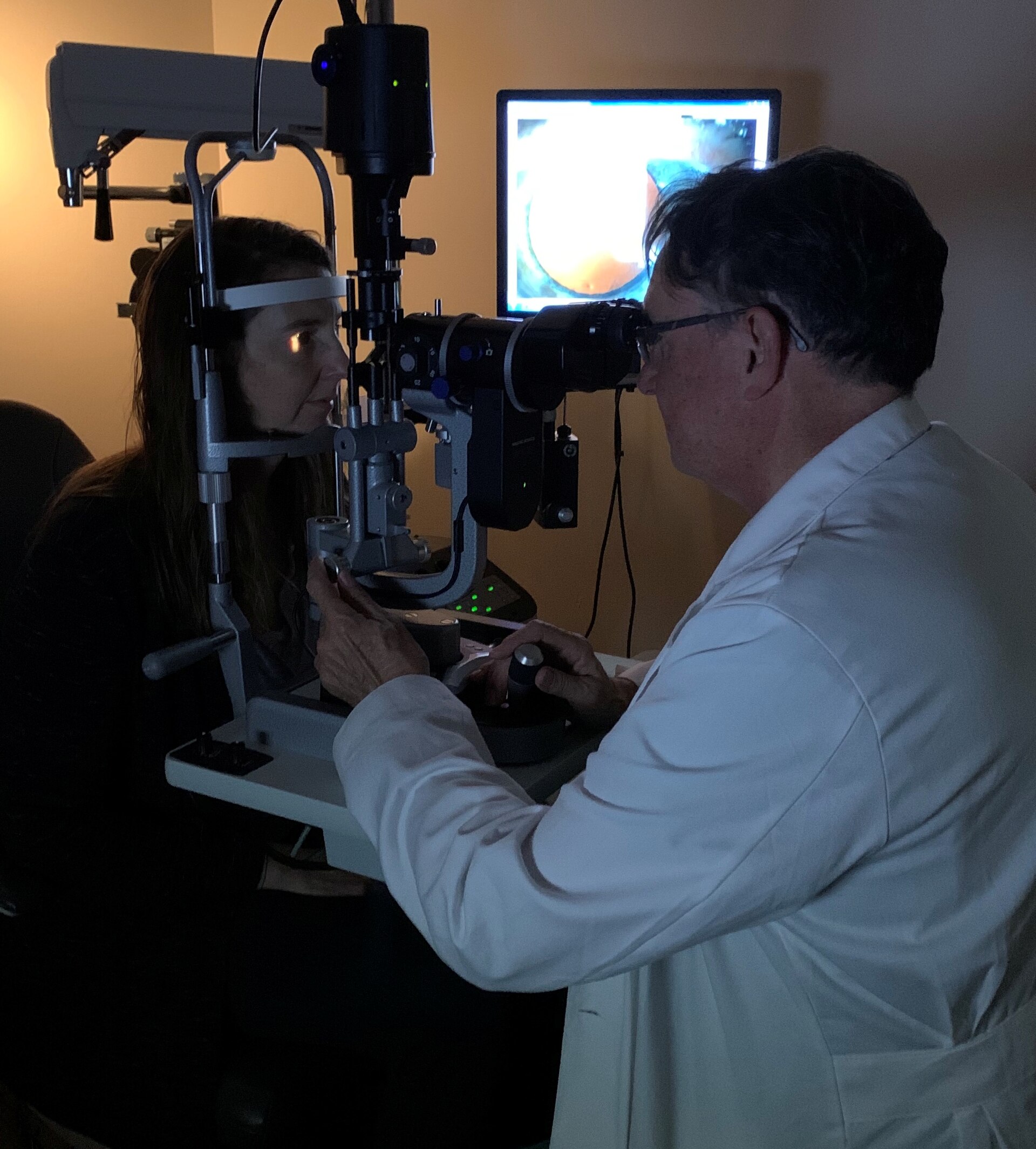 Ophthalmologist examining an eye with a slit lamp