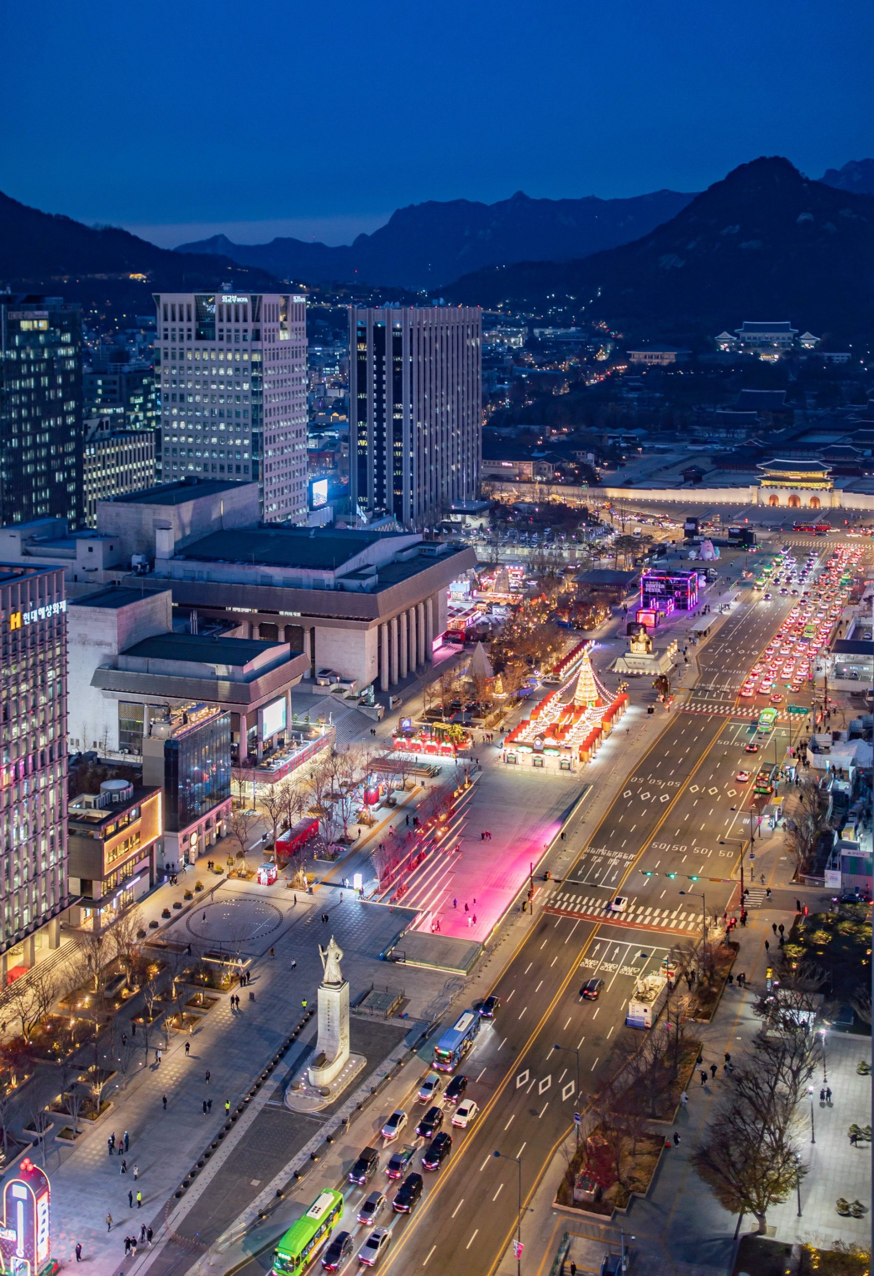 Gwanghwamun Square at night with the palace gate in the distance