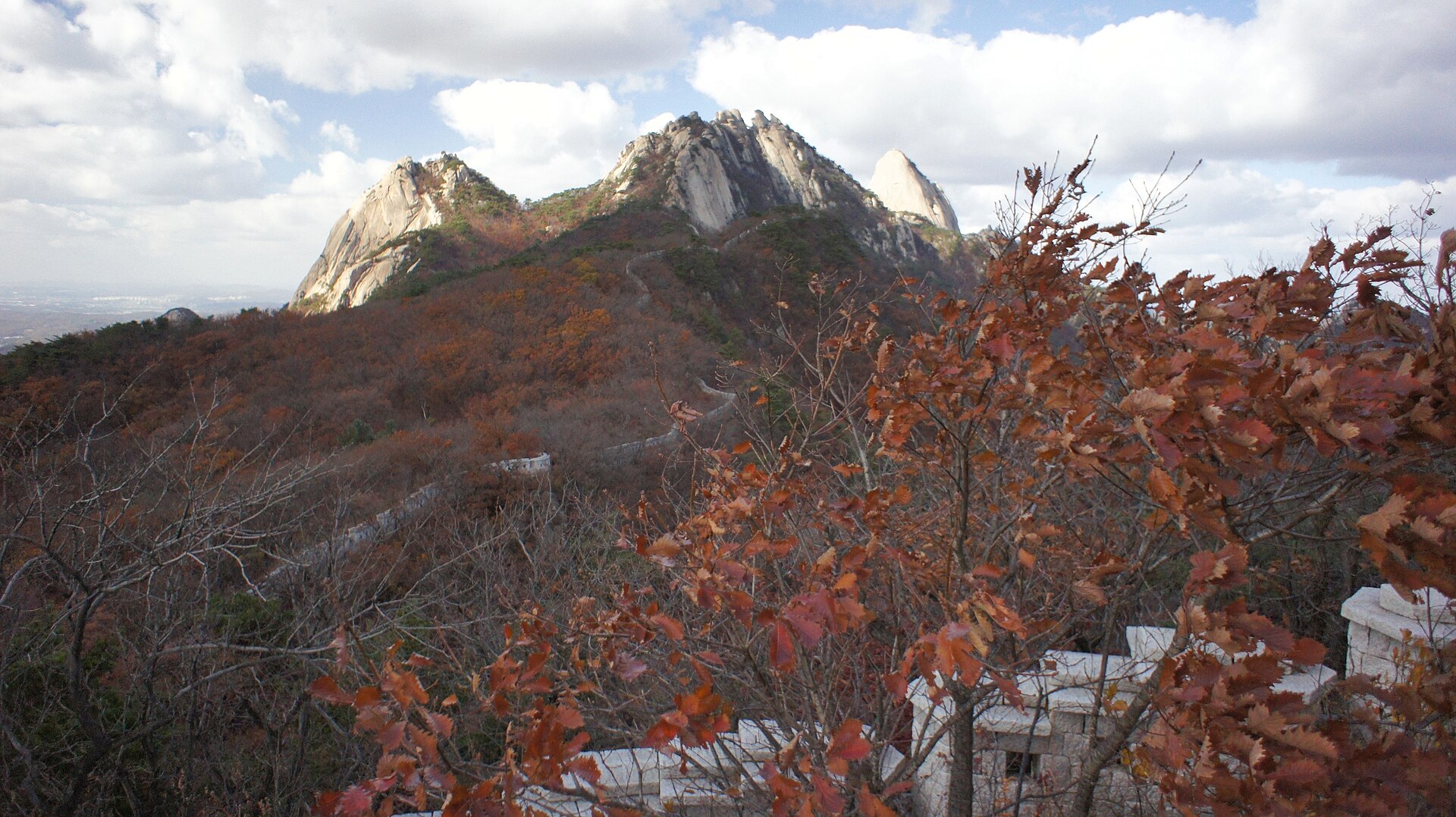 Insubong peak on Bukhansan with autumn foliage below the rock face