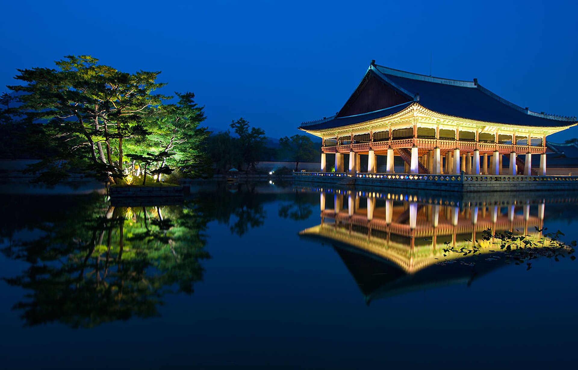 Gyeonghoeru at Gyeongbokgung at night with its lights reflected in the pond