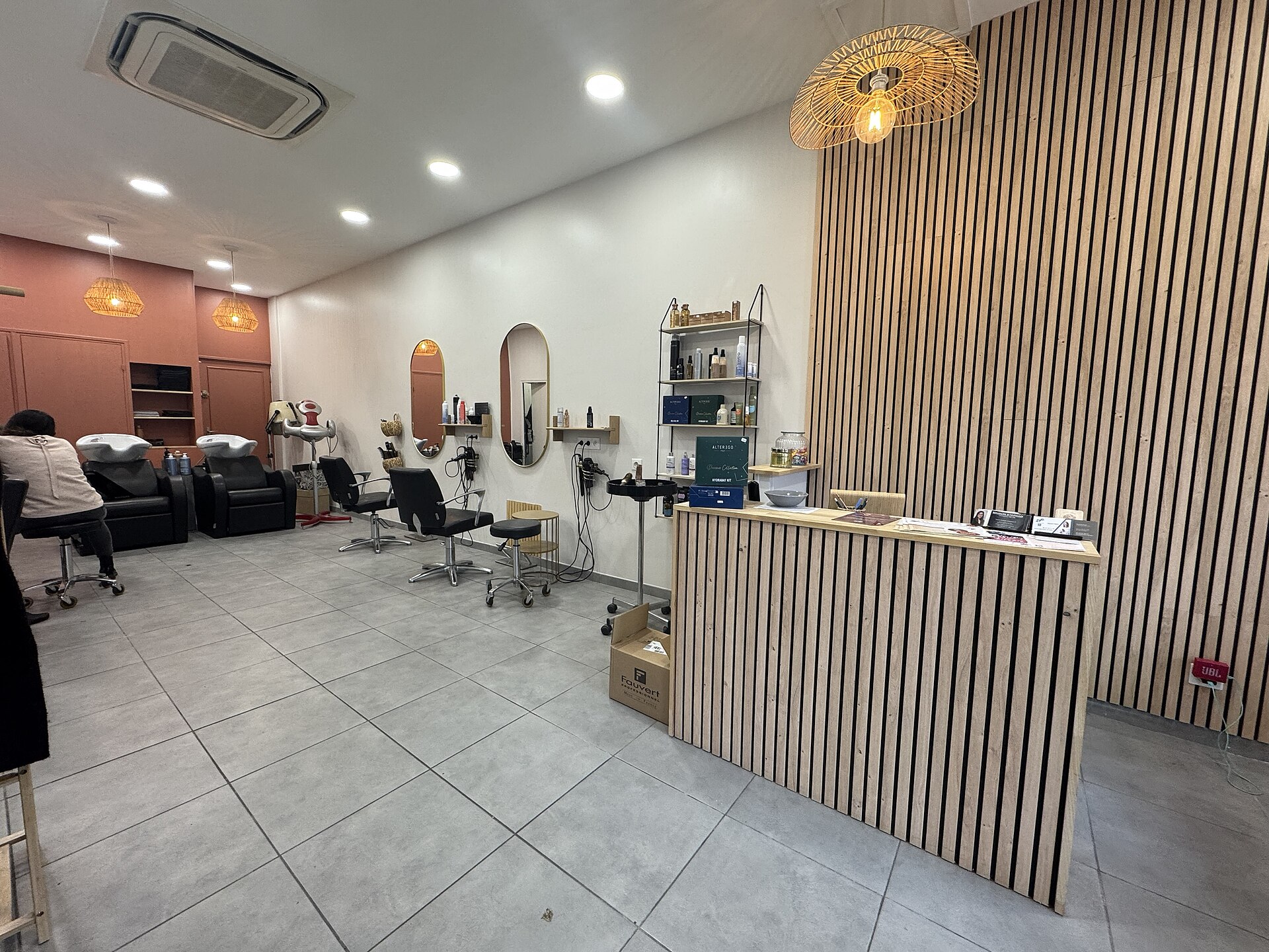 A hair salon interior with mirrors and styling chairs