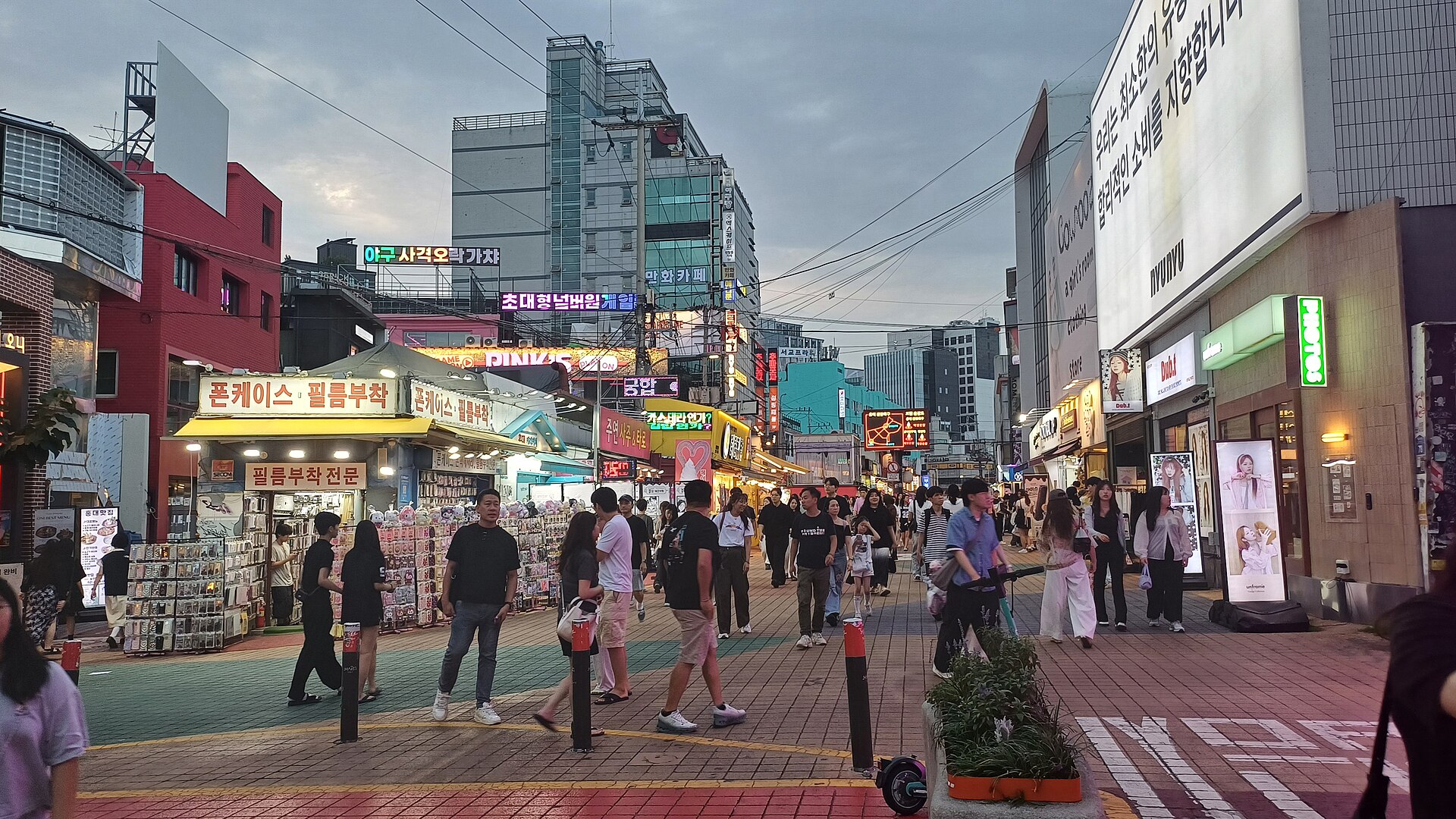 People walking along a Hongdae street by day