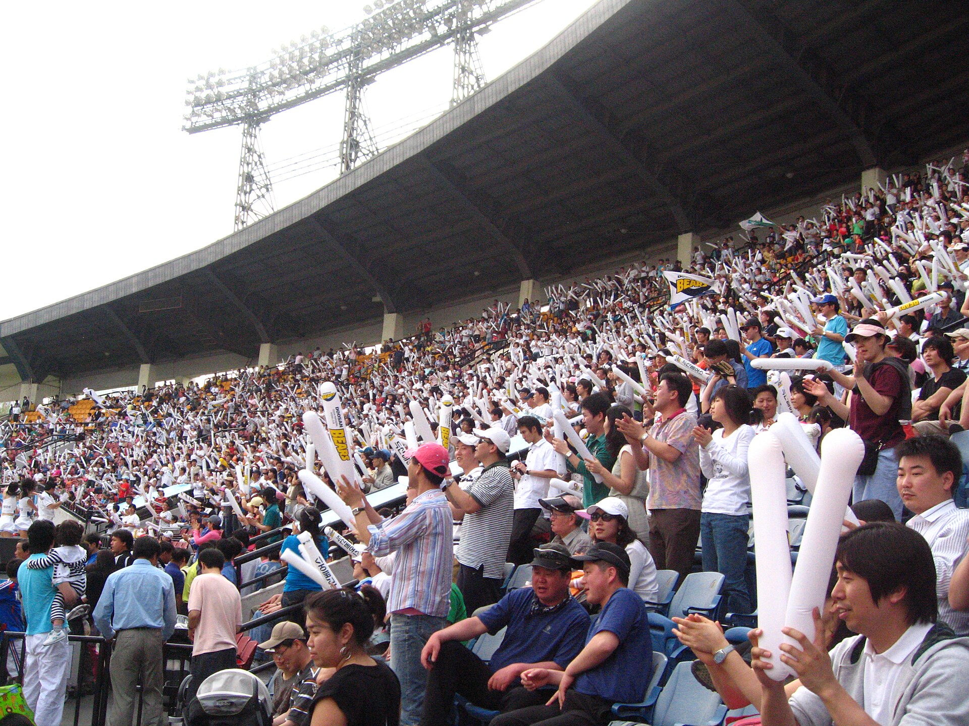 Fans on their feet cheering at Jamsil Baseball Stadium