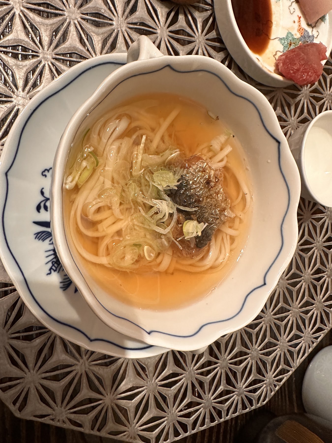 The closing bowl, thin noodles in clear broth topped with a piece of grilled fish