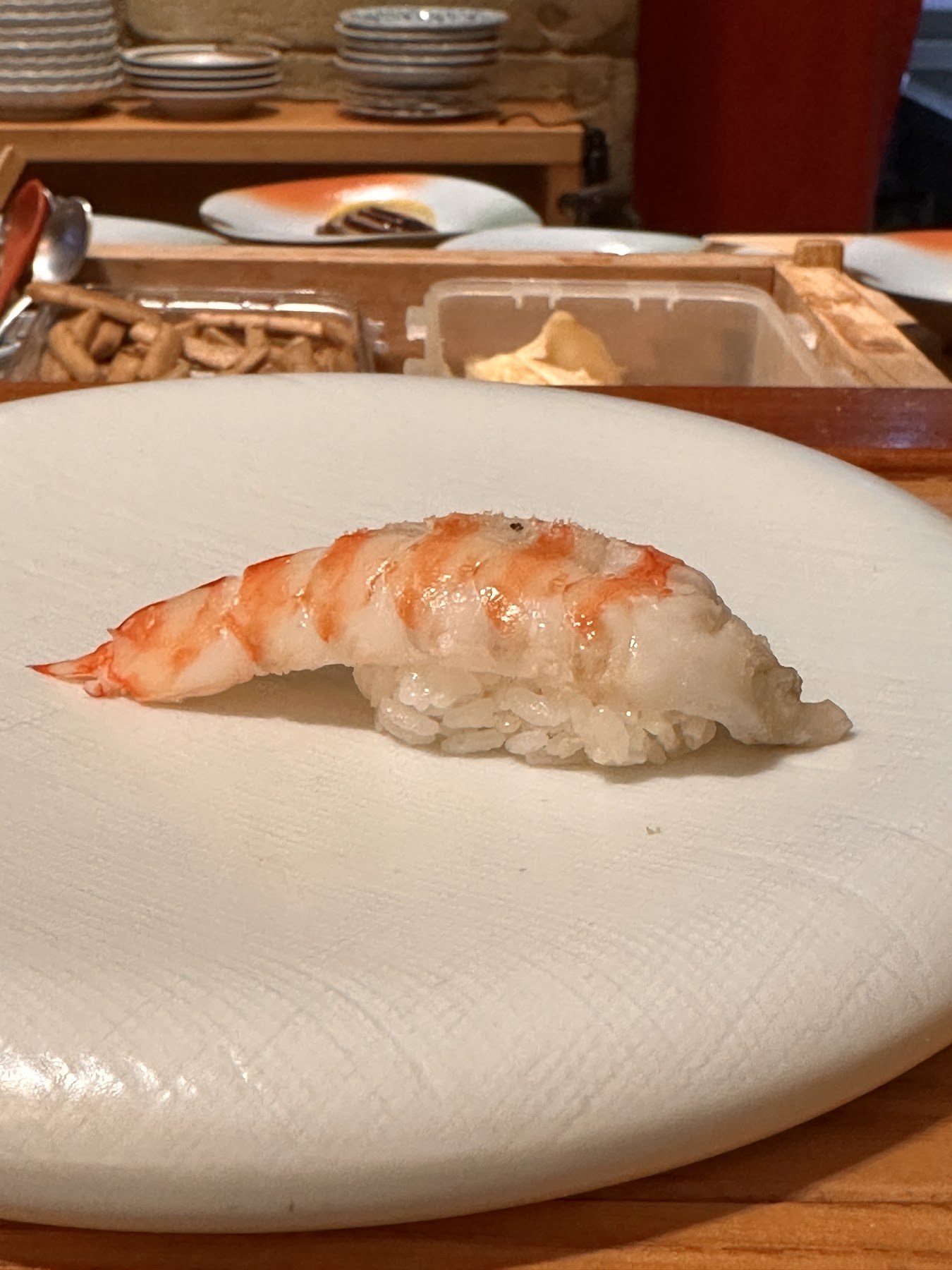 A shrimp nigiri laid over the rice