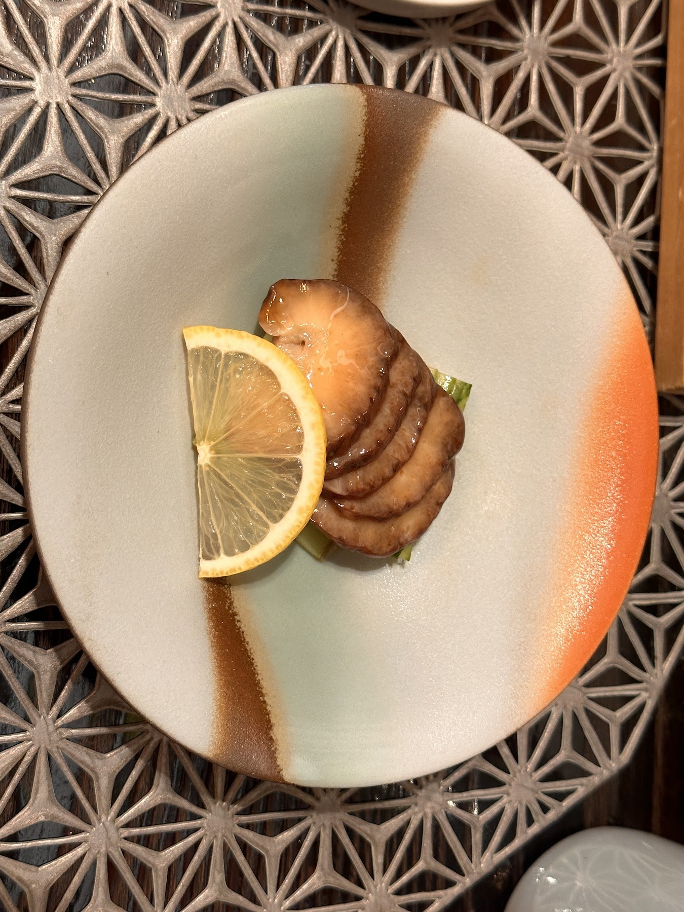 A piece braised in soy sauce with a wedge of lemon